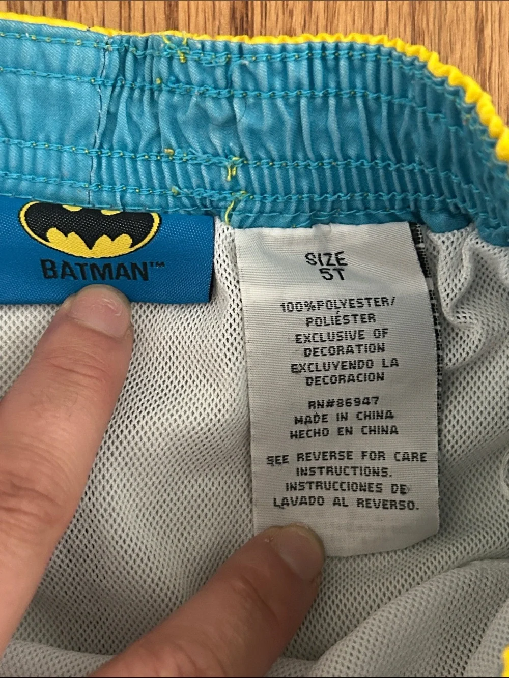 Boys Batman Blue and Yellow Graphic Swim Trunks Inner Tag Detail size 5T